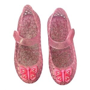 Mini Melissa pink glitter Mary Jane Jellies with pink butterflies on top of toe